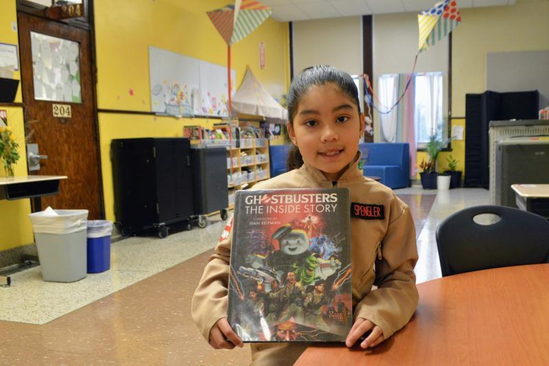 a girl holding a book