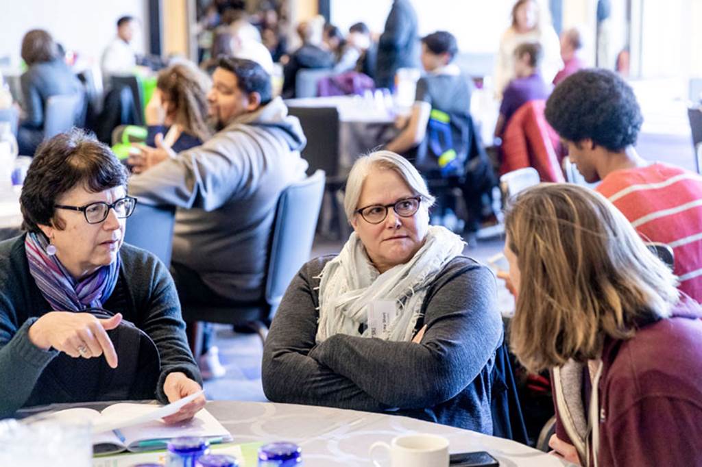 School Reform Initiative Events - Group conversation at a table