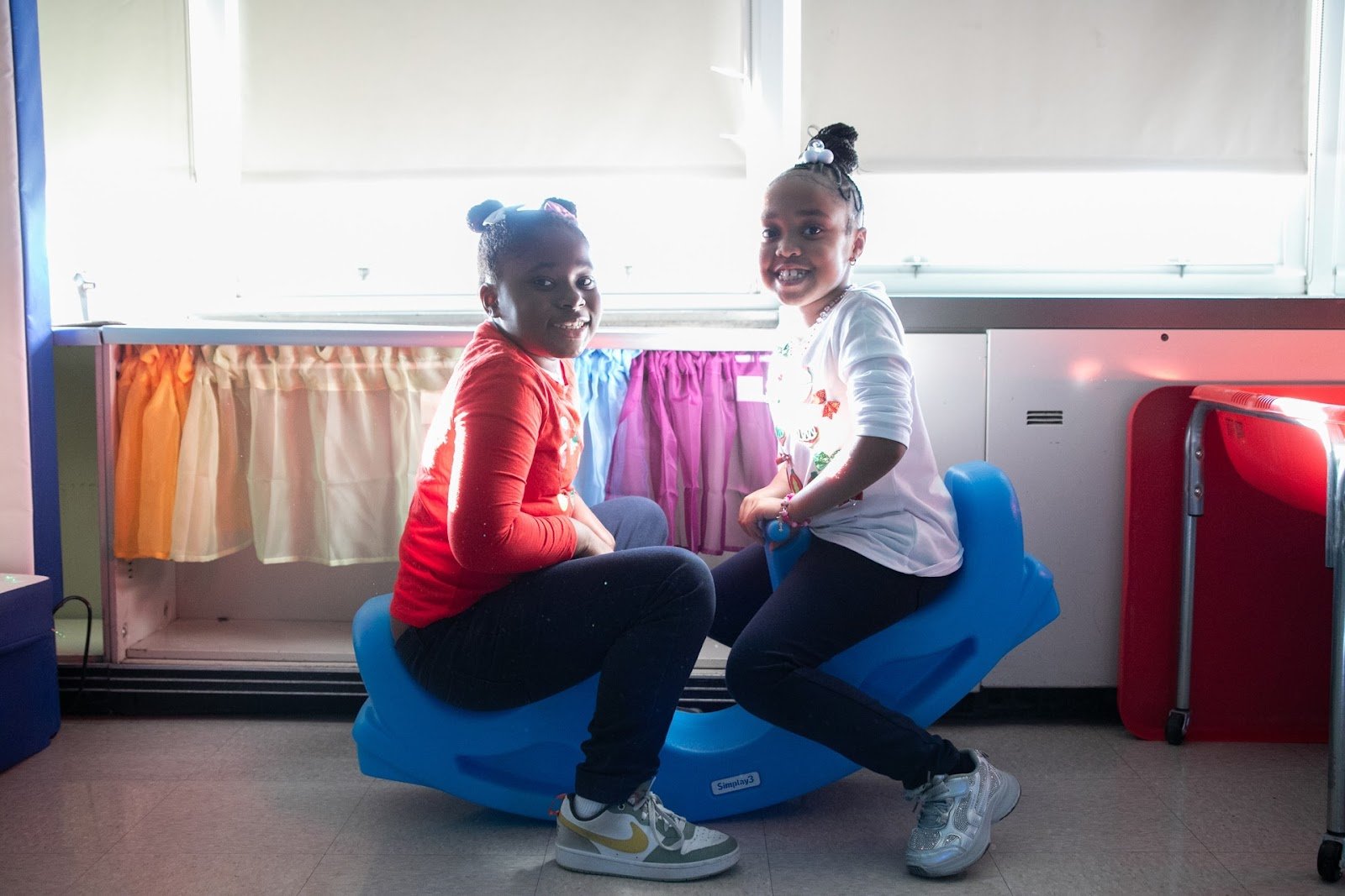 Two children playing on a seesaw