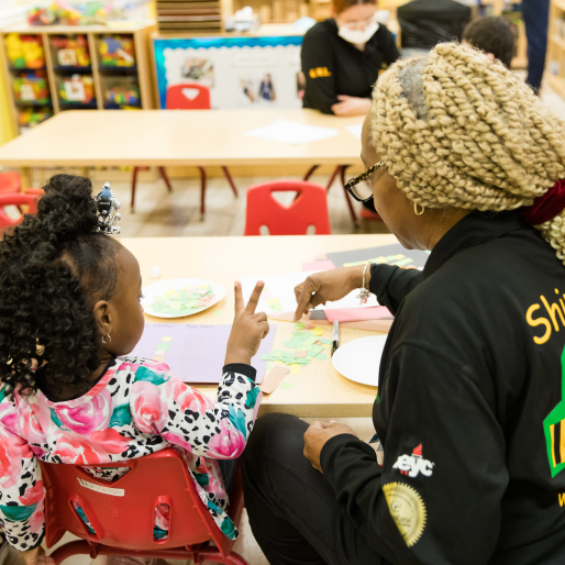 Preschool student engaging with teacher