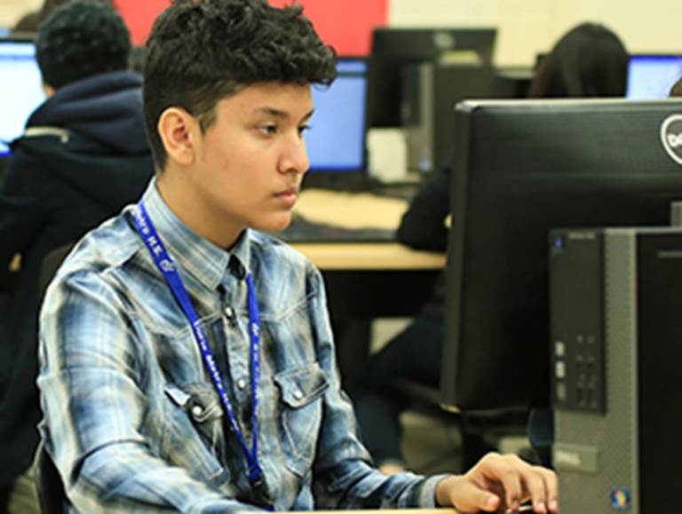 High school student typing on a keyboard