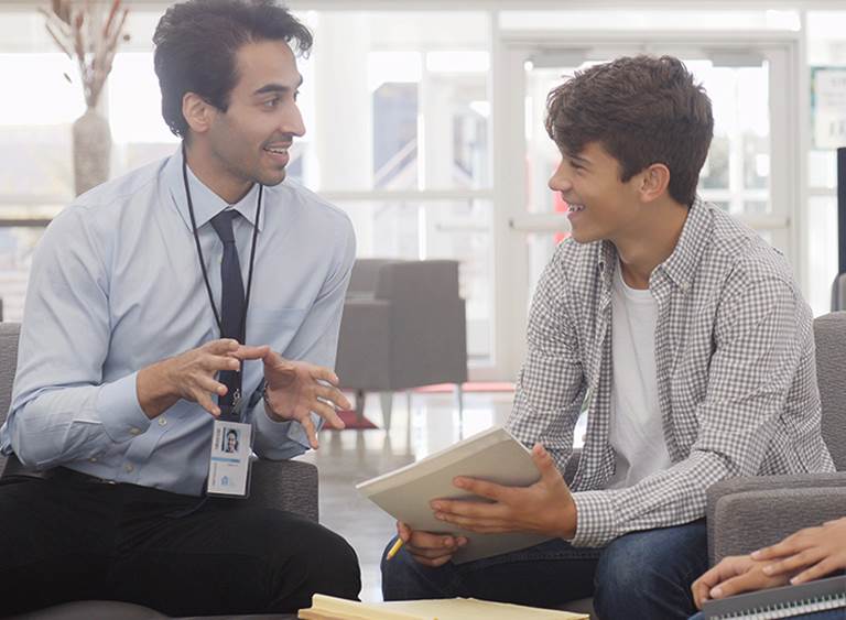 A school counselor talks with a student