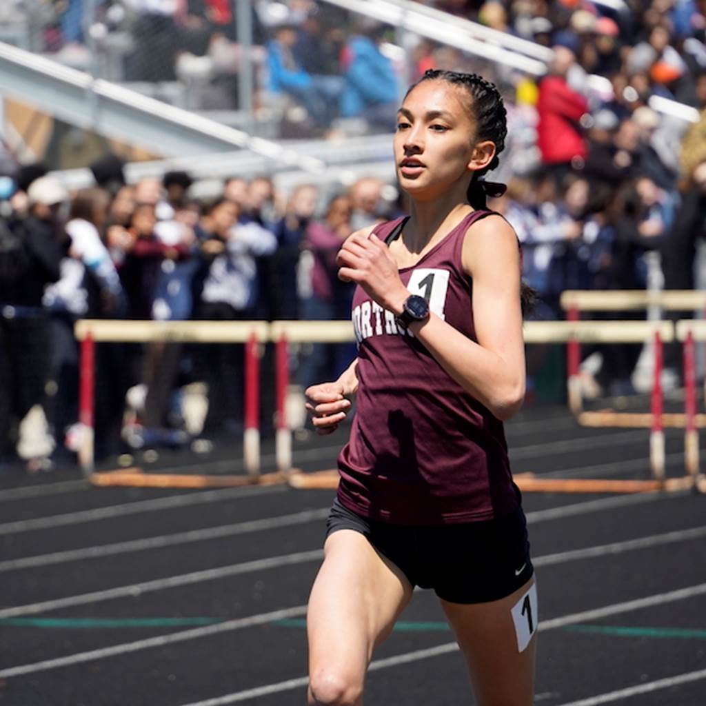 A student runs in a track race