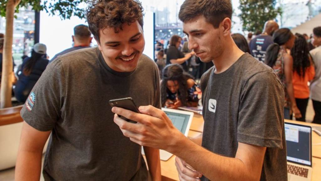 Two students look at something on a cell phone