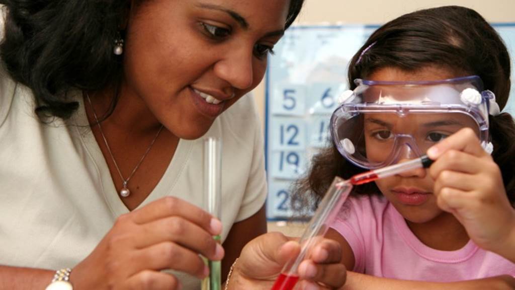 Teacher and student experimenting with test tube