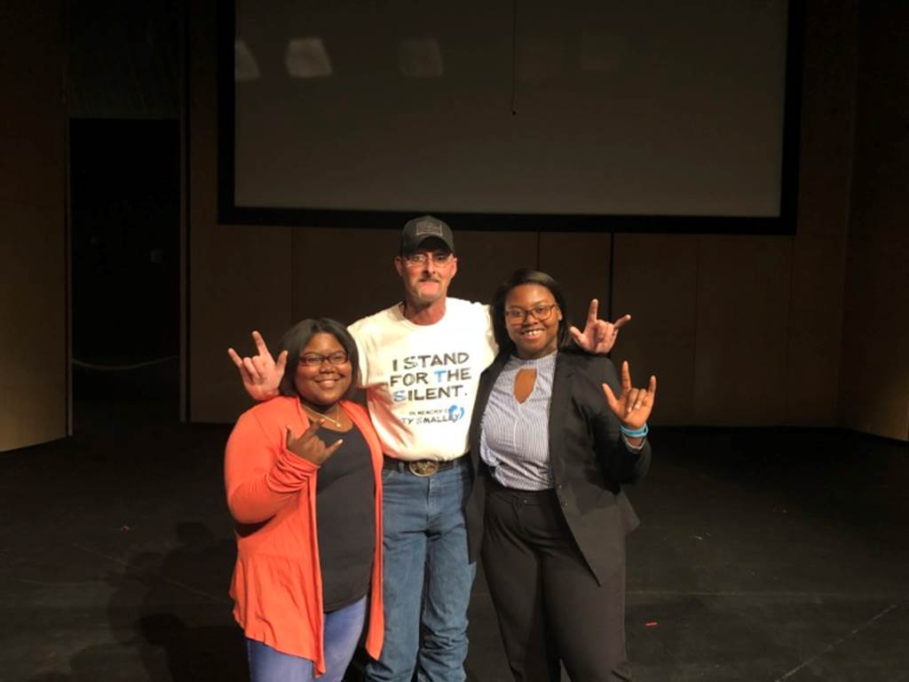 Students hold up peace signs