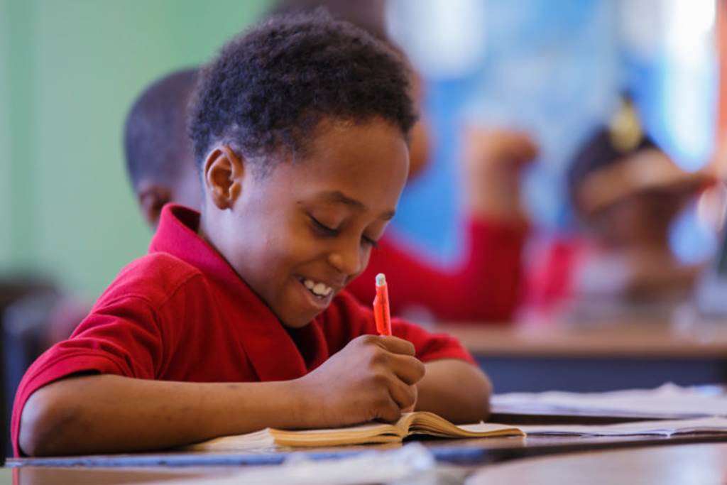 Student writing in a notebook