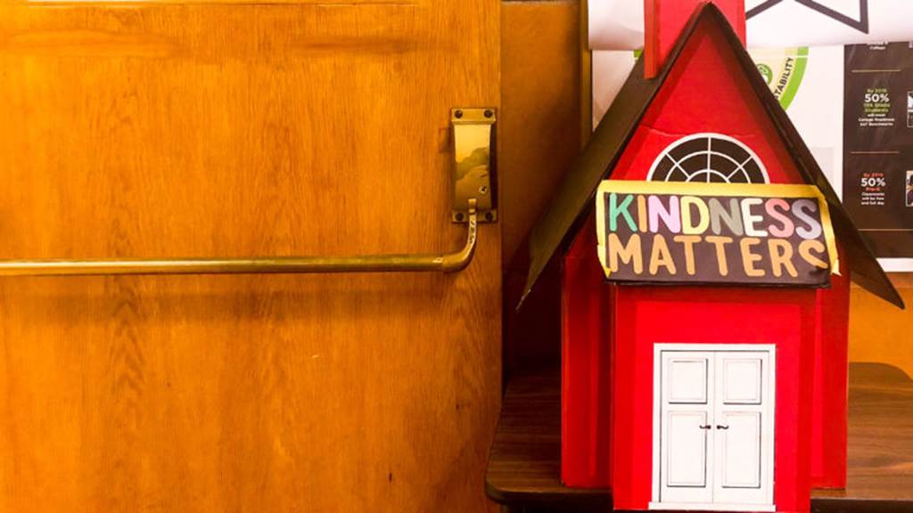 A model of a house sits next to a door