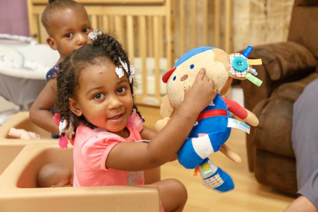 Girl playing with doll