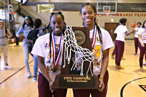 Two team mates hold a trophy