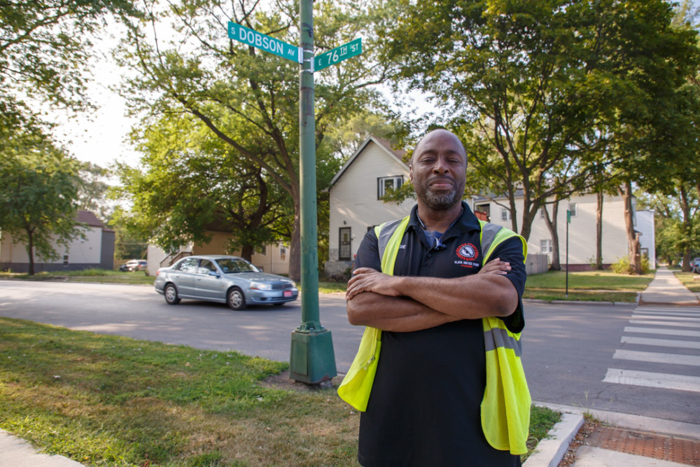 Man standing at the corner of Dobson and 76th street