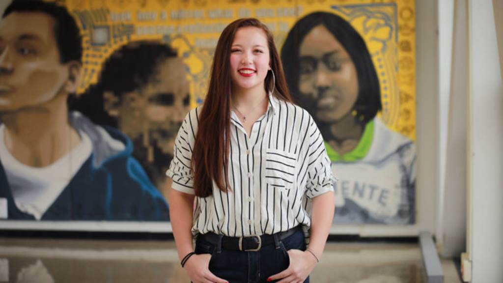 Isabella Garcia standing in front of a painting