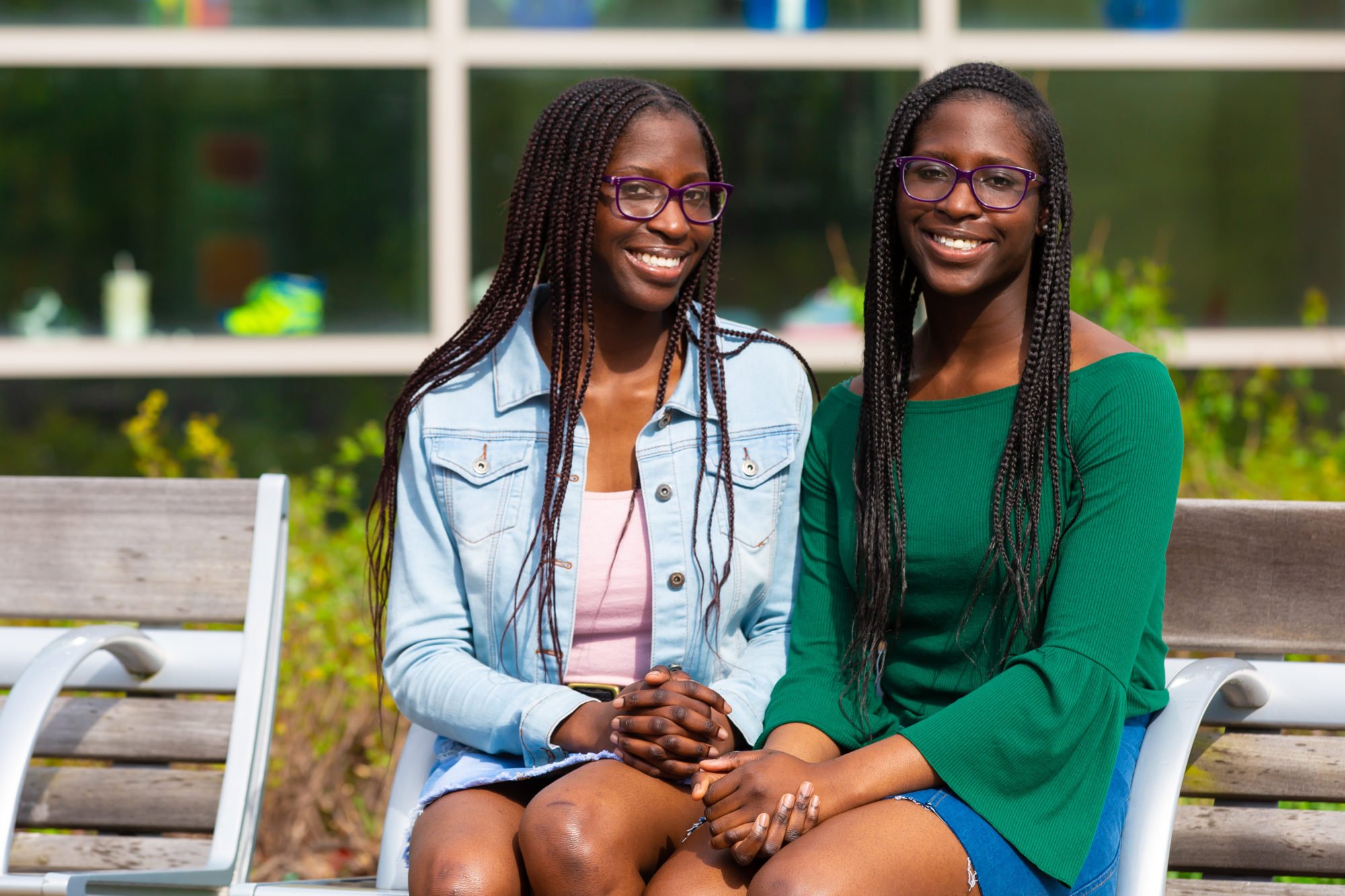 Nannette and Naomi Beckley sit on a bench