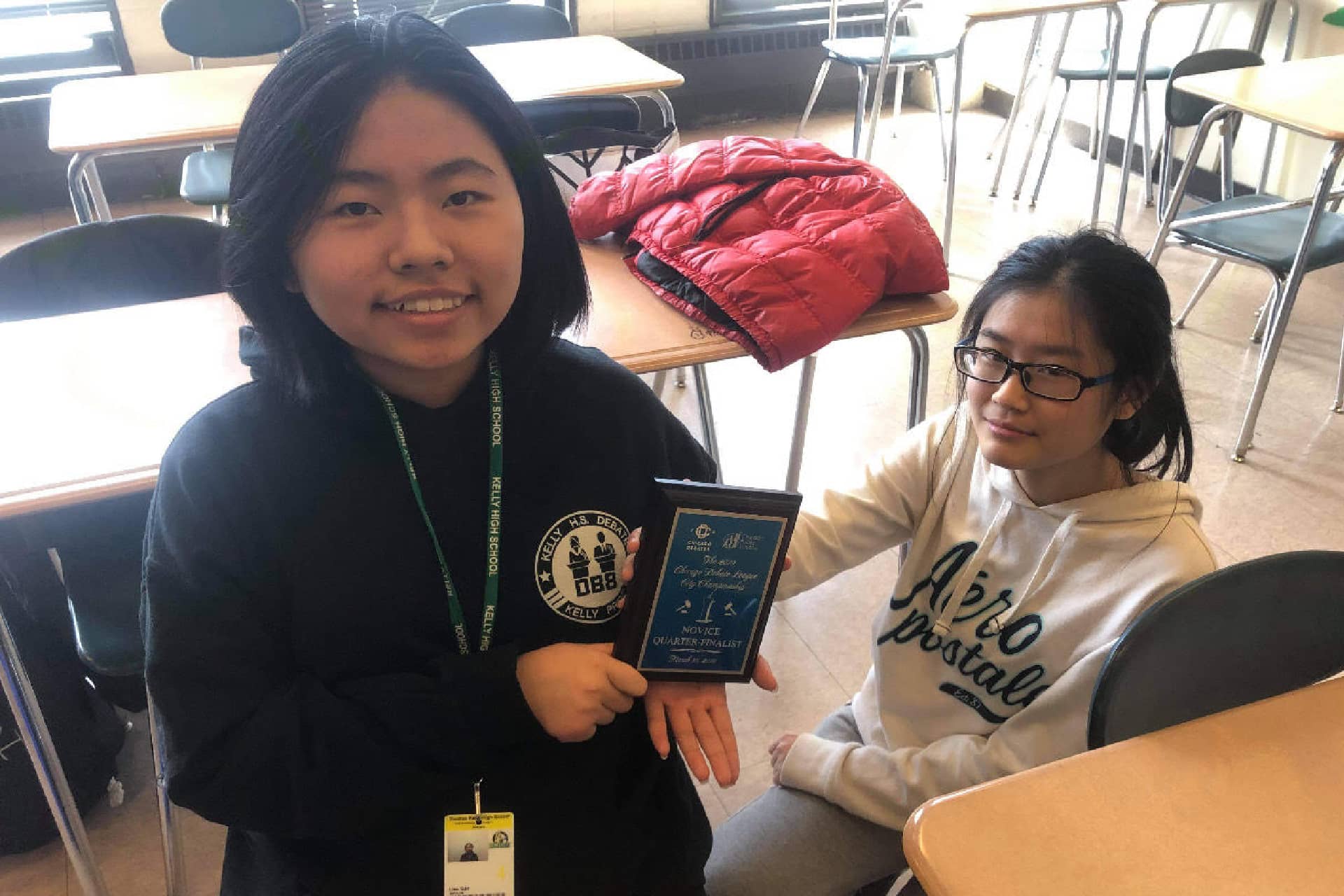 Two girls holding a plaque