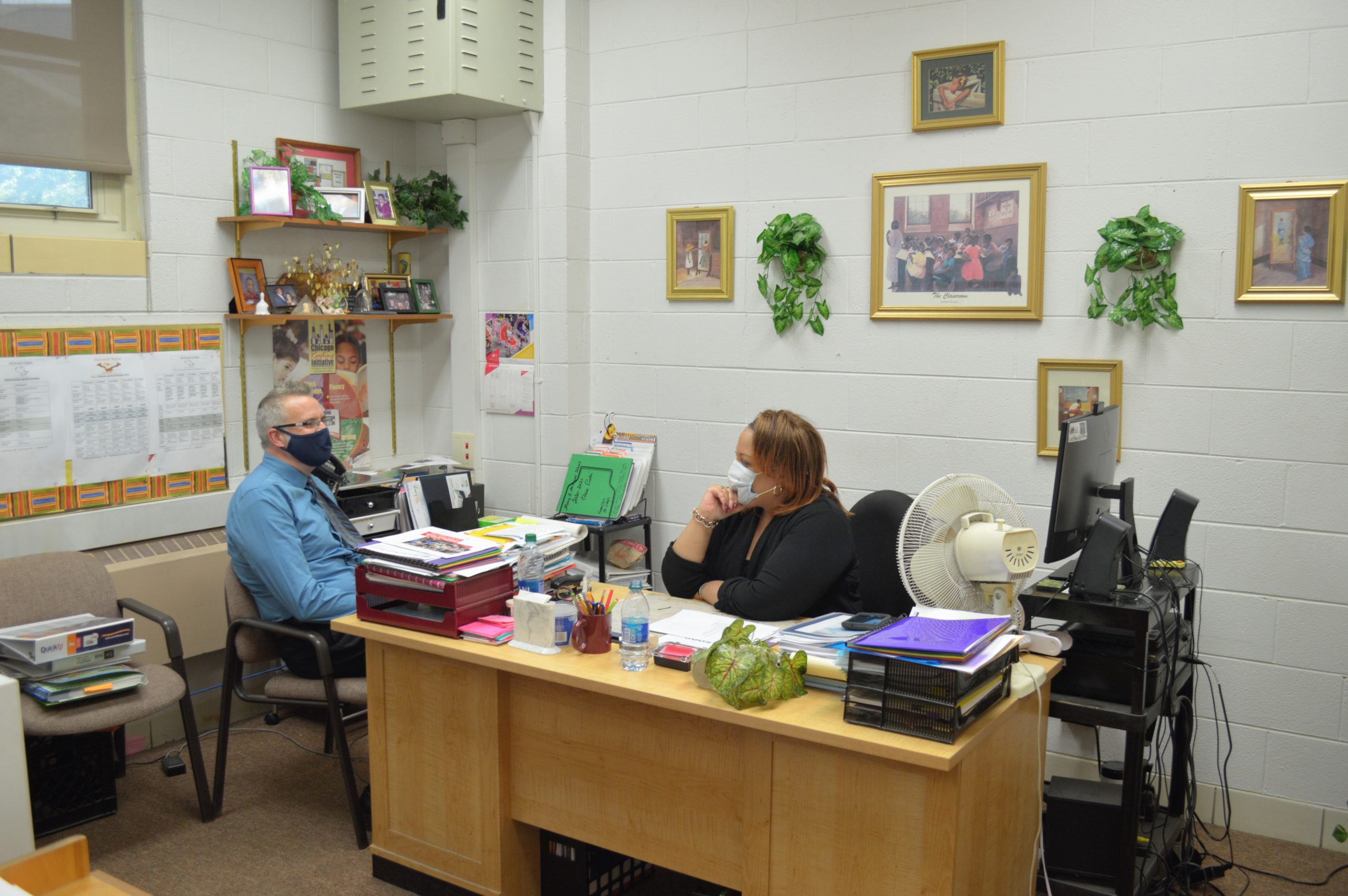 A woman and a man sitting at a desk