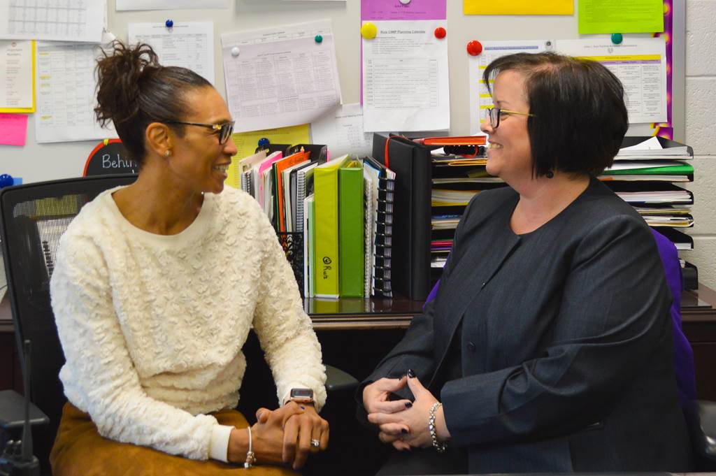 Two faculty women sitting together