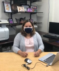 A woman sitting at her desk