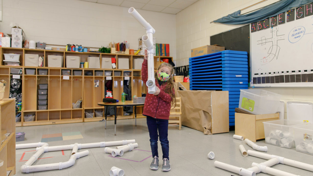 A student putting pipes together