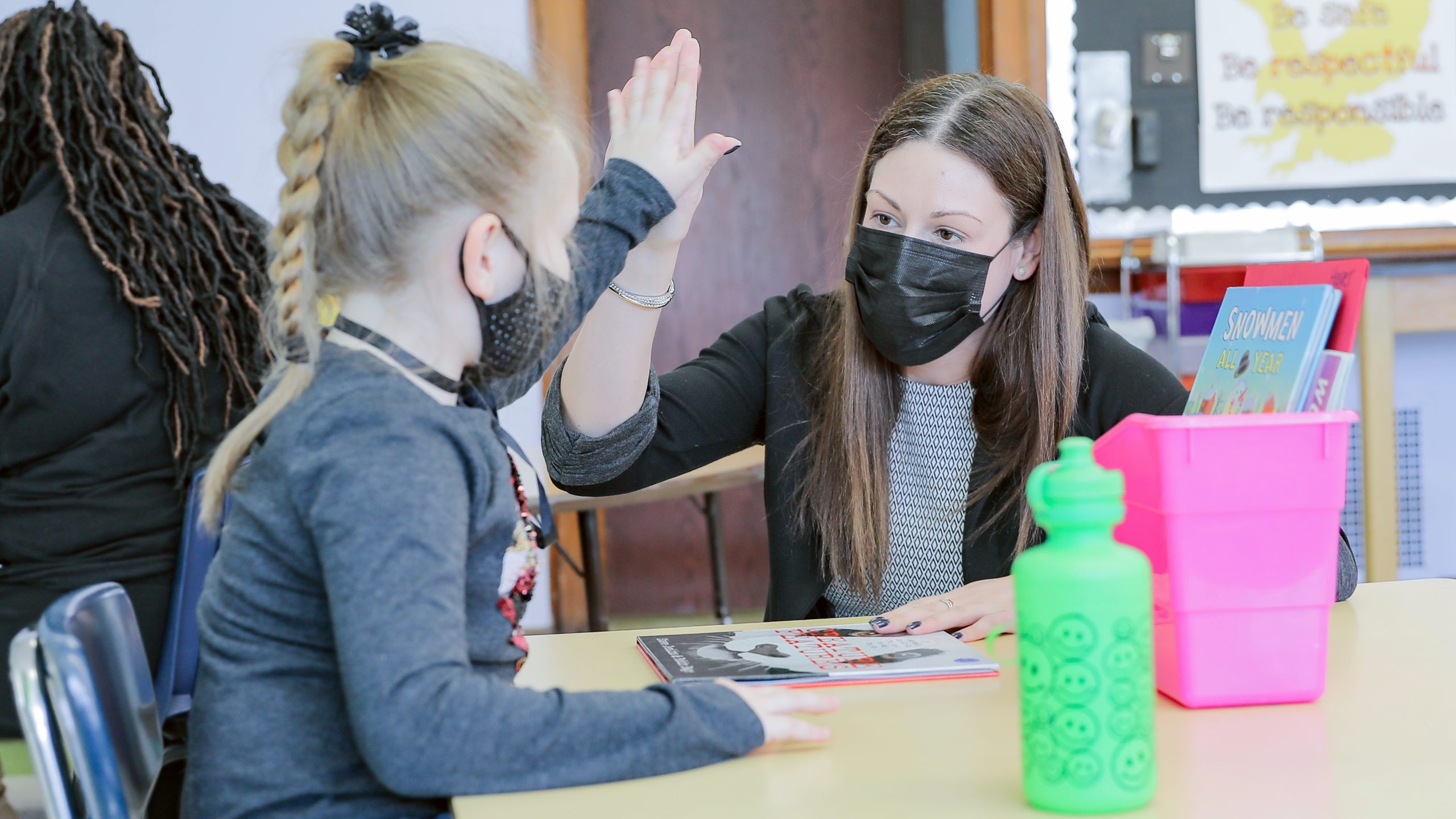 Dr. Menoni high fiving a student