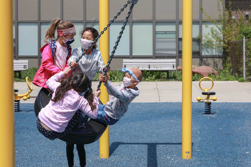 students on a tire swing