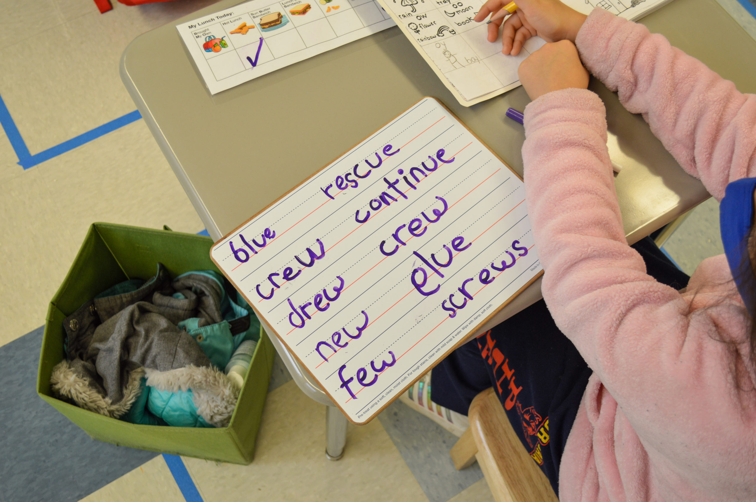 Students writing on white boards