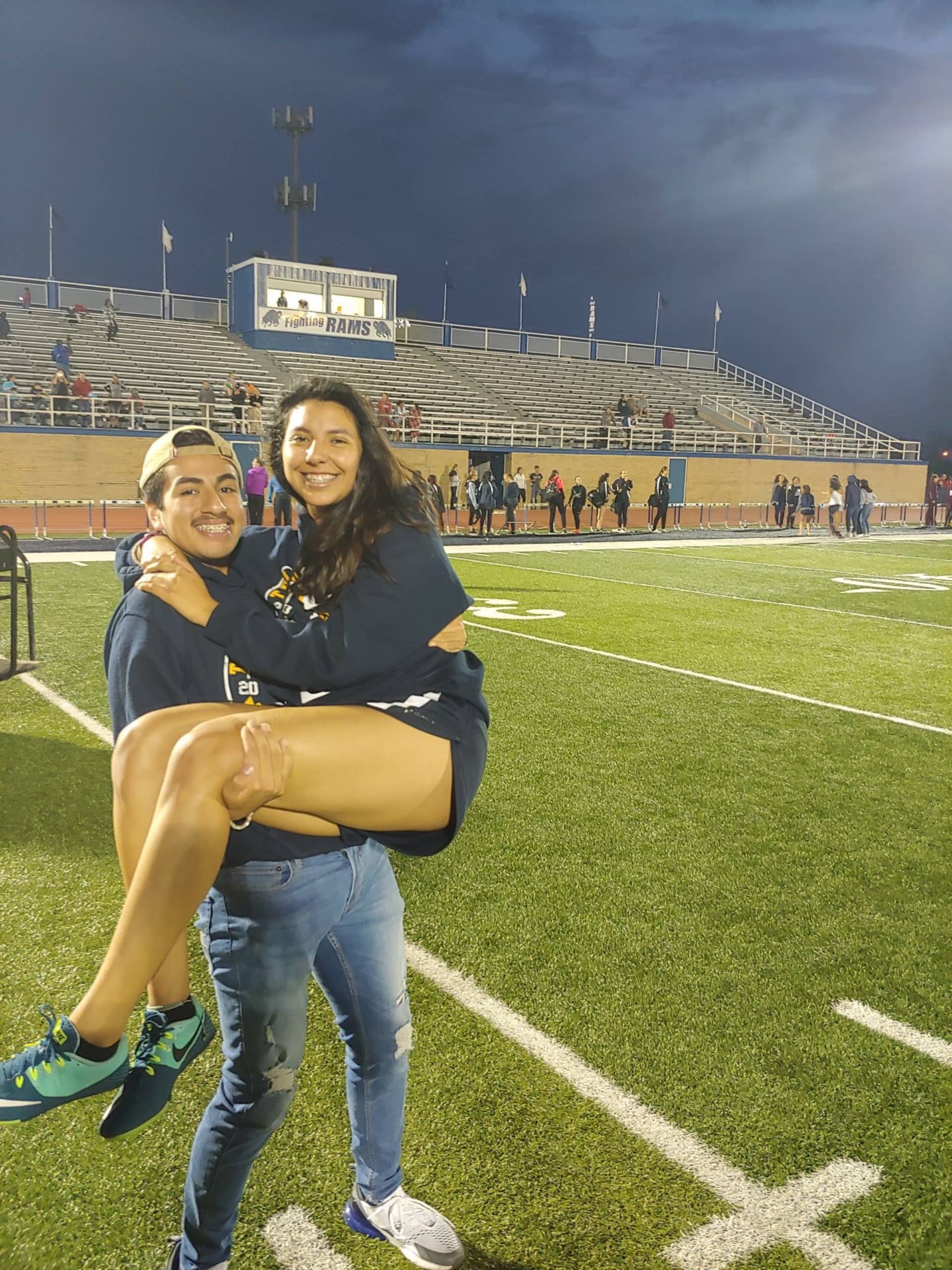 Angelo with his teammate on a football field