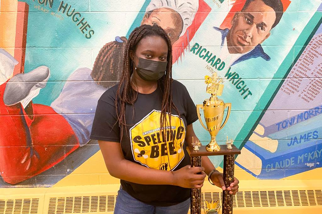 Danielle A holding a spelling bee trophy