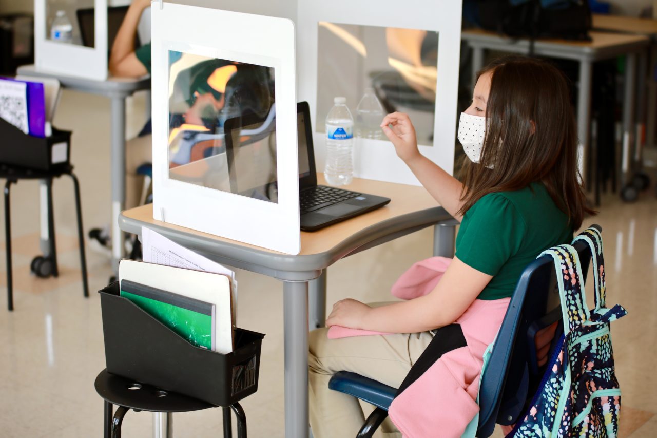 A girl sitting at her desk