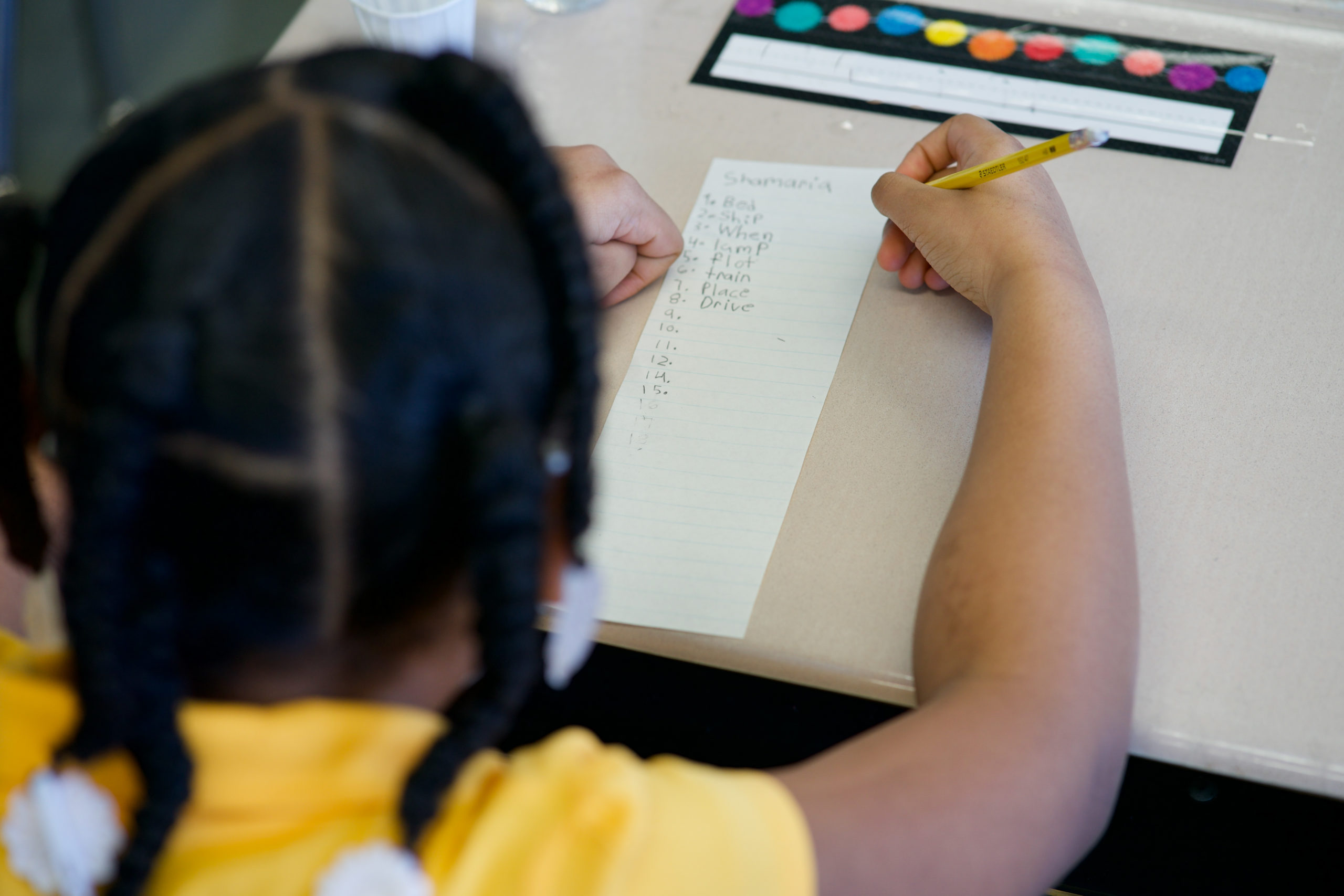 A student writing a list