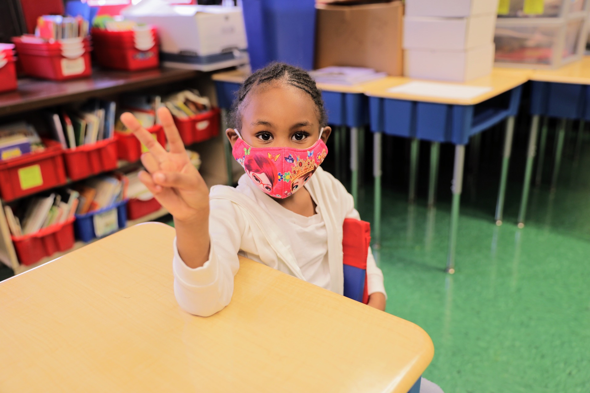 A student holding up a peace sign