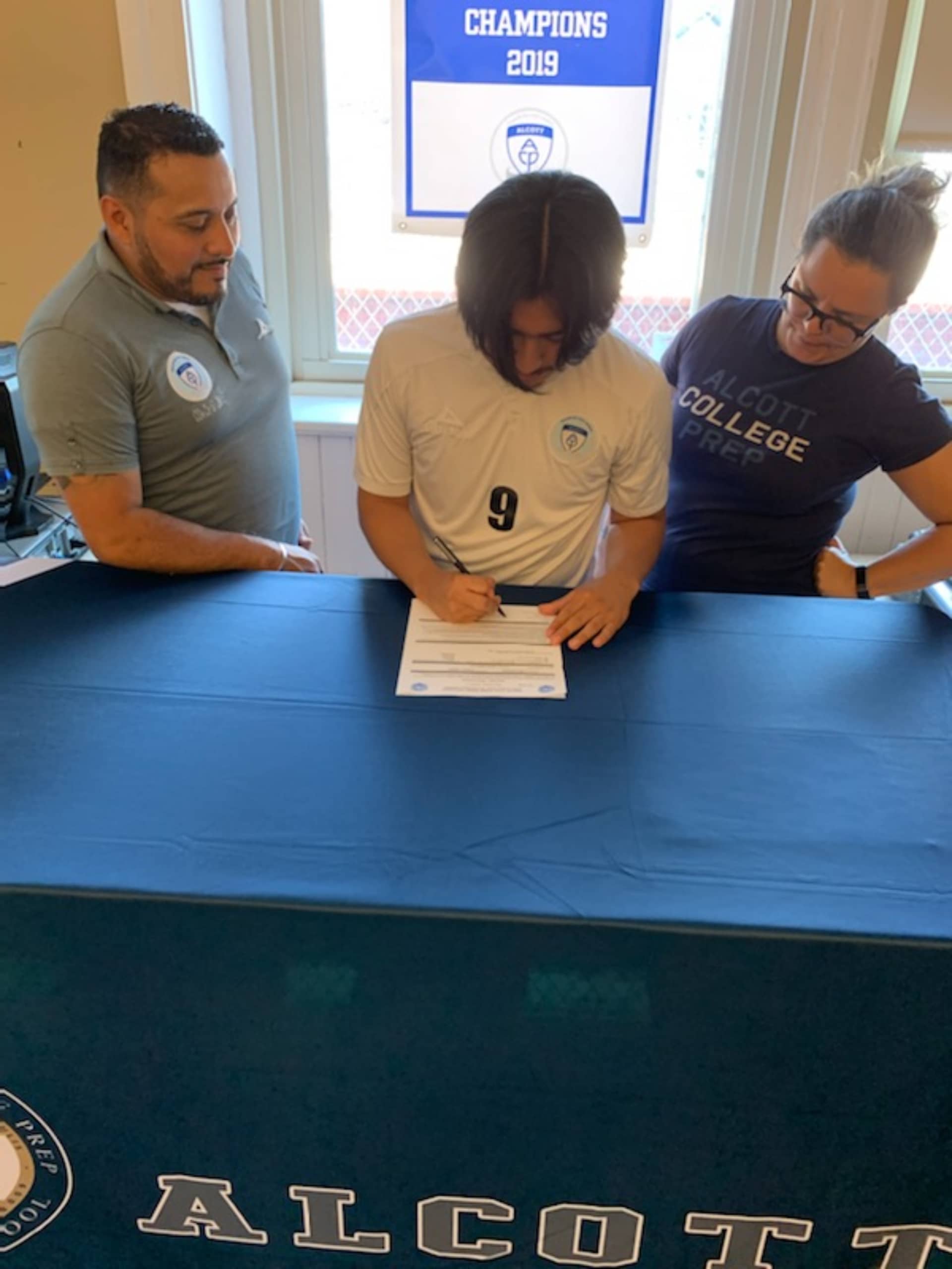 Ulises signing scholarship photos