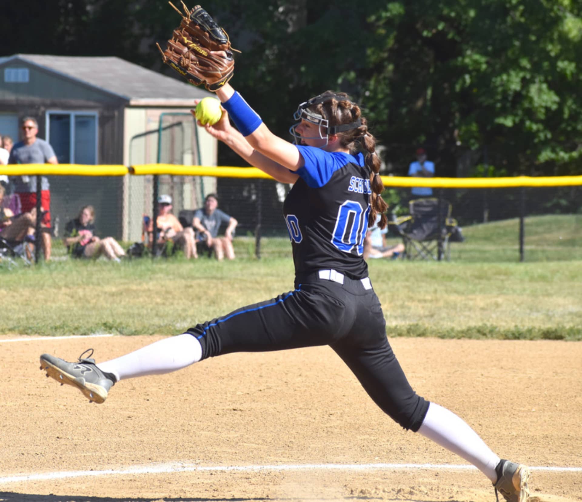 A girl throwing a softball