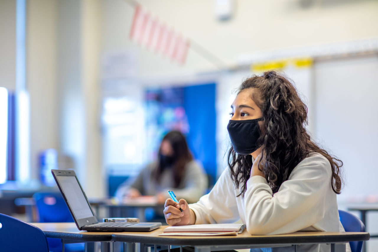 A student looking at her teacher