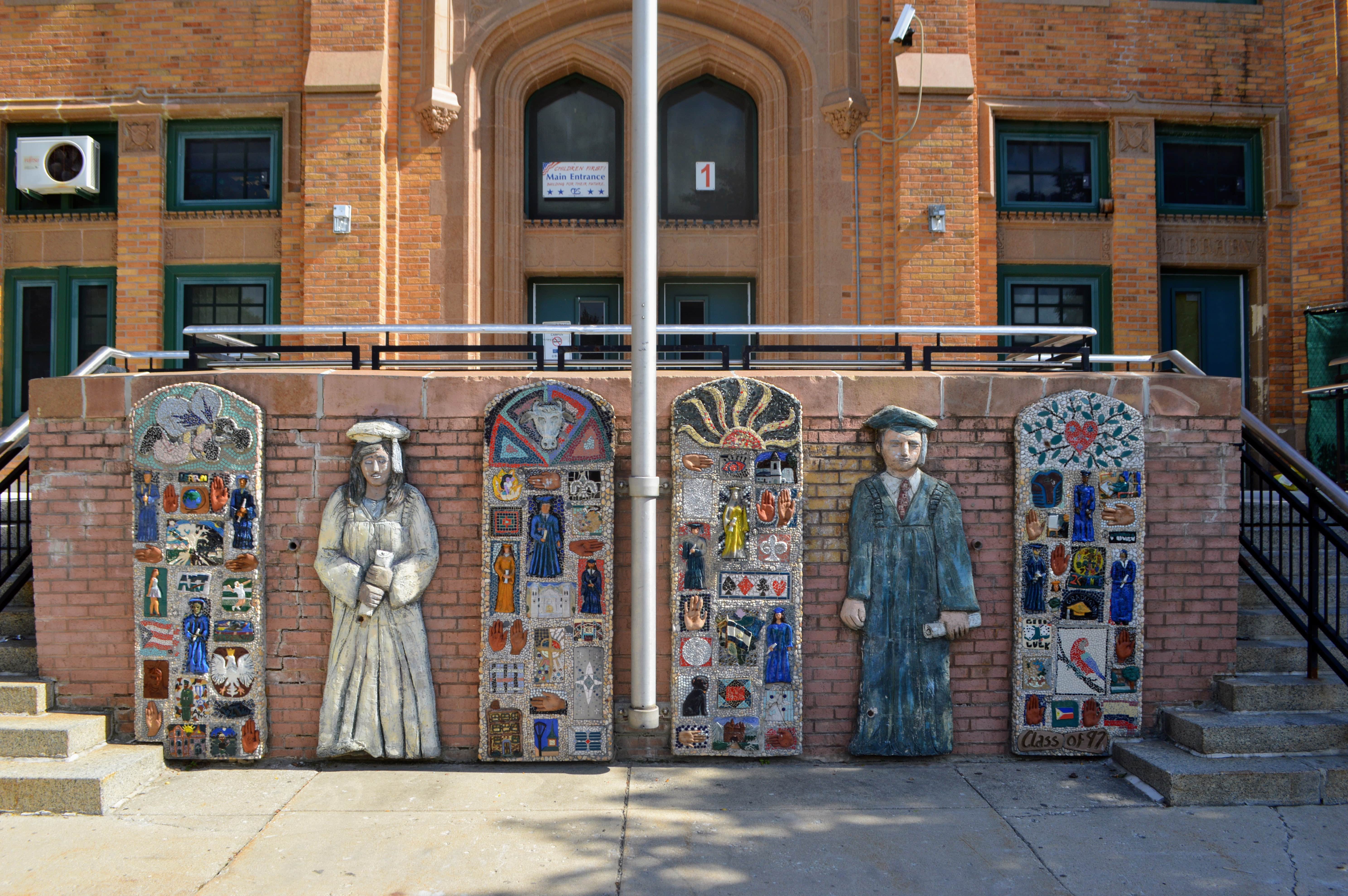 A school with a mural of graduating students standing tall