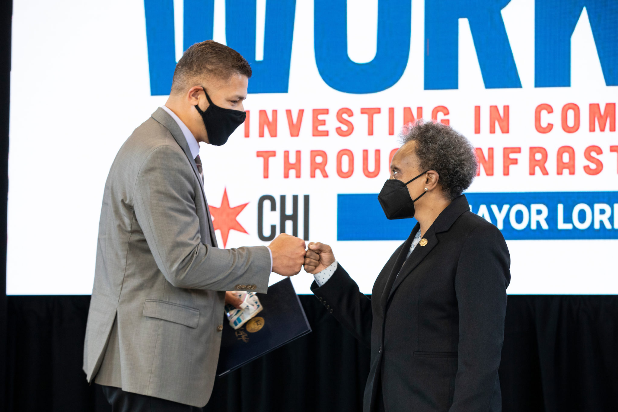 Rogelio Lopez fist bumping Mayor Lightfoot